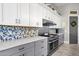 Kitchen with gray and white cabinets and tile backsplash at 8308 W Avenida Del Sol --, Peoria, AZ 85383