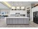 Modern kitchen with gray island and white cabinets at 8308 W Avenida Del Sol --, Peoria, AZ 85383