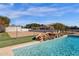 Relaxing pool area with rock waterfall, grassy area, and fenced backyard at 8308 W Avenida Del Sol --, Peoria, AZ 85383