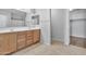 Double vanity bathroom with wood cabinets and tile floor at 8851 E Pampa Ave, Mesa, AZ 85212