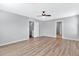 Well-lit bedroom with wood floors, ceiling fan and access to hallway at 8851 E Pampa Ave, Mesa, AZ 85212