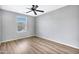 Bright bedroom with wood-look floors and ceiling fan at 8851 E Pampa Ave, Mesa, AZ 85212