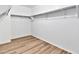 Large walk-in closet with wood-look flooring and shelving at 8851 E Pampa Ave, Mesa, AZ 85212