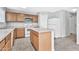 Kitchen with oak cabinets, white appliances, and an island at 8851 E Pampa Ave, Mesa, AZ 85212