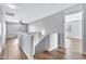 Upstairs hallway with laminate wood floors and ceiling fan at 8851 E Pampa Ave, Mesa, AZ 85212