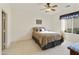 Bright bedroom with double bed, ceiling fan, and large window at 9323 E Arrowvale Dr, Sun Lakes, AZ 85248