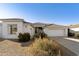 Single-story home with white exterior, two-car garage, and desert landscaping at 9323 E Arrowvale Dr, Sun Lakes, AZ 85248