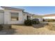 White single story home with a two car garage and desert landscaping at 9323 E Arrowvale Dr, Sun Lakes, AZ 85248