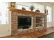 Stone fireplace with built-in shelving and entertainment center at 9323 E Arrowvale Dr, Sun Lakes, AZ 85248