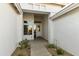 Front entry with white stucco and a glass-paned door at 9323 E Arrowvale Dr, Sun Lakes, AZ 85248