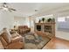 Spacious living room features a stone fireplace and large windows at 9323 E Arrowvale Dr, Sun Lakes, AZ 85248