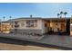 Single-wide manufactured home with carport and covered parking area at 9501 E Broadway Rd # 178, Mesa, AZ 85208