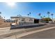 Single-wide manufactured home with carport and desert landscaping at 9501 E Broadway Rd # 178, Mesa, AZ 85208