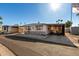 Single-wide manufactured home with carport and small front yard at 9501 E Broadway Rd # 178, Mesa, AZ 85208