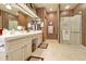 Large bathroom with double vanity and walk-in shower at 9509 E Arrowvale Dr, Sun Lakes, AZ 85248