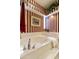 Relaxing bathroom with soaking tub and striped wallpaper at 9509 E Arrowvale Dr, Sun Lakes, AZ 85248