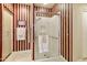 Bathroom with walk-in shower and striped wallpaper at 9509 E Arrowvale Dr, Sun Lakes, AZ 85248