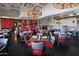 Bright dining area with red and gray seating and a wood-fired oven at 9509 E Arrowvale Dr, Sun Lakes, AZ 85248