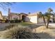 Single-story home with landscaped yard and two-car garage at 9509 E Arrowvale Dr, Sun Lakes, AZ 85248