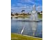 Tranquil lake with a fountain and a Great Egret at 9509 E Arrowvale Dr, Sun Lakes, AZ 85248