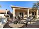 Covered patio with comfortable seating and fire pit at 9509 E Arrowvale Dr, Sun Lakes, AZ 85248