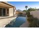 Long rectangular pool with patio and surrounding landscaping at 9509 E Arrowvale Dr, Sun Lakes, AZ 85248