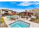 Community pool and spa with relaxing patio furniture at 1 Easy St # 12, Carefree, AZ 85377