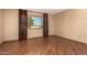 Bright bedroom featuring wood-look flooring and large window at 10161 W Pineaire Dr, Sun City, AZ 85351