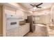 White cabinets, granite counters, and built-in microwave at 10161 W Pineaire Dr, Sun City, AZ 85351