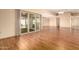 Living room with wood floors and sliding glass doors leading to a patio at 10161 W Pineaire Dr, Sun City, AZ 85351