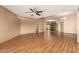 Living area with wood floors, ceiling fan, and mirrored wall at 10161 W Pineaire Dr, Sun City, AZ 85351