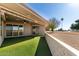 Covered patio with artificial turf and golf course view at 10161 W Pineaire Dr, Sun City, AZ 85351