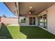 Covered patio with artificial turf and sliding glass doors at 10161 W Pineaire Dr, Sun City, AZ 85351