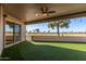 Covered patio with artificial turf and golf course view at 10161 W Pineaire Dr, Sun City, AZ 85351