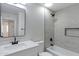 Modern bathroom with white vanity, grey tile, and a bathtub at 1104 N Oak Ct, Gilbert, AZ 85233