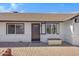 Front entrance of a charming home with a dark brown door and brick walkway at 1104 N Oak Ct, Gilbert, AZ 85233