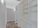 Hallway with built-in white shelving and wood-look flooring at 1104 N Oak Ct, Gilbert, AZ 85233