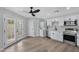 Modern kitchen with white cabinets, stainless steel appliances, and light wood flooring at 1104 N Oak Ct, Gilbert, AZ 85233