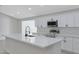 Modern kitchen with white cabinets, quartz countertops, and a large island at 1104 N Oak Ct, Gilbert, AZ 85233