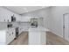 Modern kitchen with white cabinets, island, and stainless steel appliances at 1104 N Oak Ct, Gilbert, AZ 85233