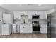 Modern kitchen with white shaker cabinets and stainless steel appliances at 1104 N Oak Ct, Gilbert, AZ 85233