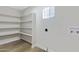 Bright laundry room with ample shelving and vinyl flooring at 1104 N Oak Ct, Gilbert, AZ 85233