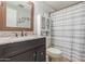 Bathroom with granite countertop, dark vanity, and shower/tub at 1126 S 97Th Way, Mesa, AZ 85208