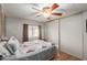 Bedroom with double bed, ceiling fan, and sliding door closet at 1126 S 97Th Way, Mesa, AZ 85208