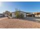 Single-wide manufactured home with covered carport and desert landscaping at 1126 S 97Th Way, Mesa, AZ 85208