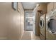 Laundry room with washer, dryer, and exterior access at 1126 S 97Th Way, Mesa, AZ 85208