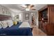 Main bedroom with king bed, built-in entertainment center and walk-in closet at 1126 S 97Th Way, Mesa, AZ 85208