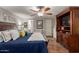 Main bedroom with king bed, built-in entertainment center and walk-in closet at 1126 S 97Th Way, Mesa, AZ 85208