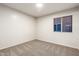 Bright bedroom featuring a window with blinds and carpet flooring at 11670 W Pine Mountain Ct, Surprise, AZ 85378