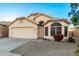 Single-story home with a two-car garage and desert landscaping at 11670 W Pine Mountain Ct, Surprise, AZ 85378